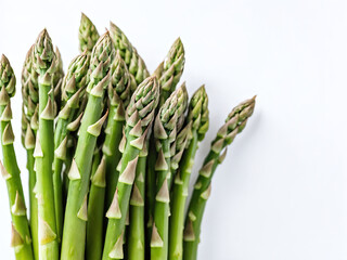 Close up view of fresh green asparagus spears on white background