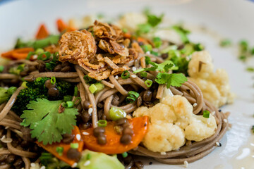Japanese buckwheat pasta with lentils and vegetables in a bowl