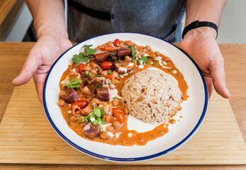A vegetarian massaman curry in a bowl with sweet potato and many spices