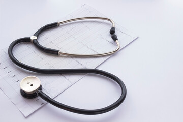 Stethoscope, cardiogram and the image of the heart on  light background