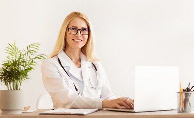 Experienced Doctor Working On Medical Expertise, Using Laptop In Office, free space