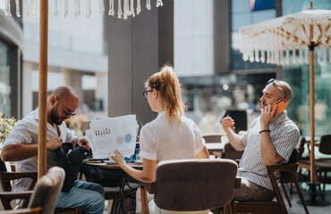 Startup team in a business meeting outdoors discussing, brainstorming, and analyzing data. Collaboration and planning for new strategies and ideas in a relaxed environment.