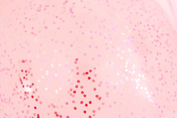 Pink blurred background with glitter confetti, pastel rose pink color	