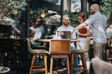 A group of business workers collaborating in a coffee bar, brainstorming ideas and sharing knowledge while working remotely.