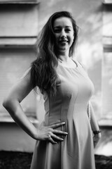 Portrait of a young beautiful dark-haired girl in nature in black and white style.
