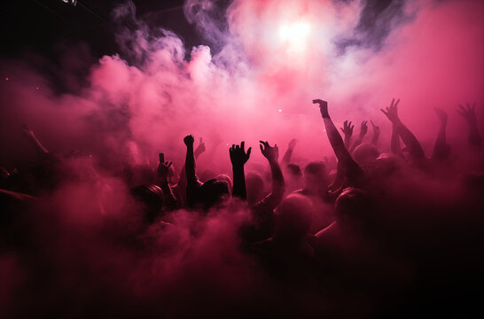 Enthusiastic crowd dancing and enjoying music in a club with pink lighting and smoke effects, creating a lively atmosphere