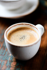 Cup of coffee on wooden background. Close up.	