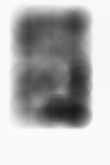 A blurry dreamy view of a vintage leaded glass window in black and white negative.