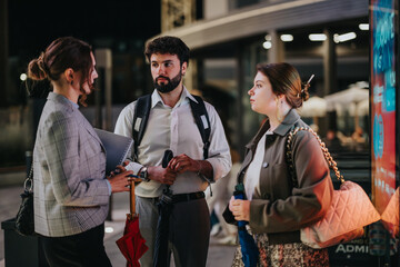Young business people meeting outdoors, discussing marketing, brainstorming ideas, and analyzing reports for their small company's expansion.