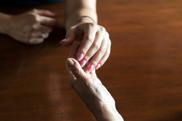 Two pairs of hand touching each other, together, helping hands