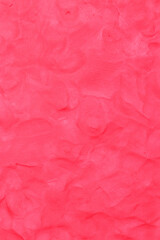 Red Plasticine textured background has rough surface. Abstract. By using your hand to knead it to flatten and have fingerprints attached. House wall for background or website wallpaper.