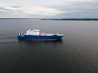 A transport ferry ship sails near the islands in the Baltic Sea from the port of Paldiski. Photo view from a drone.
