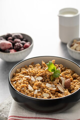 Crispy homemade granola with sliced almonds in a bowl. Healthy food