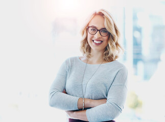 Portrait, arms crossed and happy business woman in startup for career, job and pride. Face, smile and confident entrepreneur in glasses, professional and creative digital strategist in Switzerland