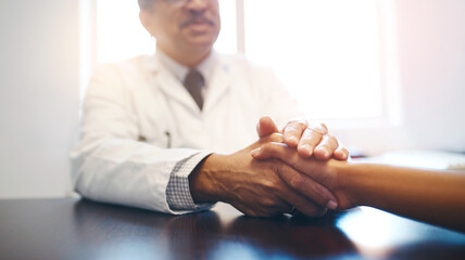 Comfort, doctor and holding hands of patient for help, healthcare or empathy after cancer...
