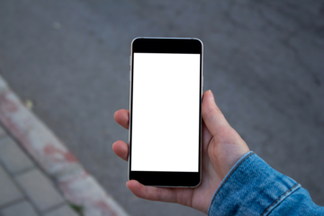 Hand holding blank screen smartphone at the outdoor, mockup phone, transparent background png