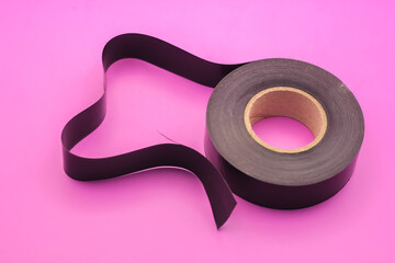 Black Electrical Tape isolated on purple background