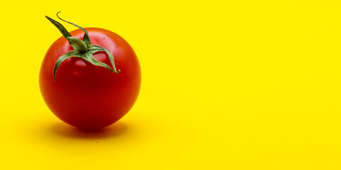 red Tomato isolated on yellow background 