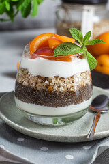 Granola with yogurt, chia and apricots in a glass
