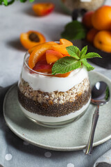 Granola with yogurt, chia and apricots in a glass
