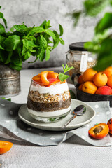 Granola with yogurt, chia and apricots in a glass
