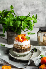 Granola with yogurt, chia and apricots in a glass
