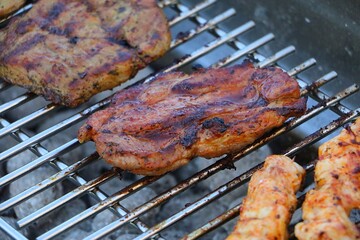 close-up of grilled meat lying on the grill and being cooked