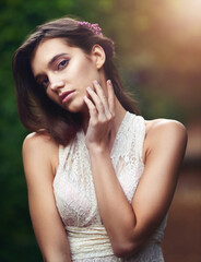 Naklejka premium Woman, portrait and garden with eco fashion, fairytale and flowers in hair with confidence outdoor. Spring, park and elegance in forest and woods with princess, green and glamour style in nature