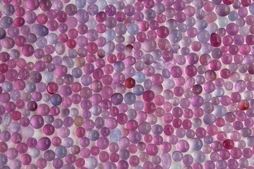 Close up pattern of purple silica gel bead, on white background