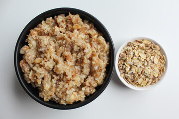 Comparison of rolled oat, before and after cooking. Isolated on white background, flat lay or top view