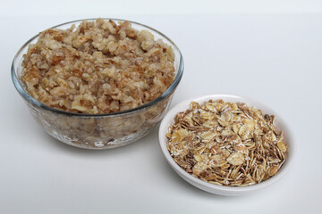 Comparison of rolled oat, before and after cooking. Isolated on white background
