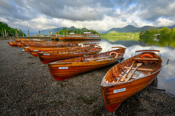 Wooden rowing boats on shoreline of Derwentwater on a Summer morning. Keswick, Lake District, UK. © _Danoz