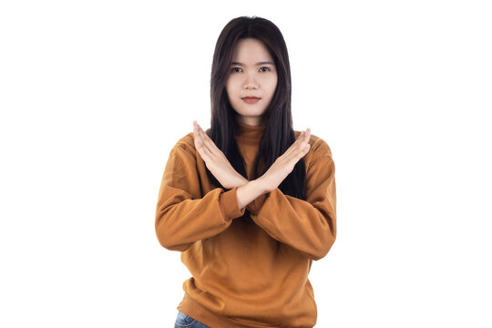 A young Asian woman seen making a rejection gesture with her hand forward isolated on a white background with clipping path.