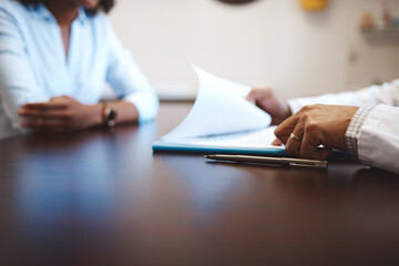 Hands, paperwork and pen at table for medical, application for health insurance. Doctor, patient and document for wellness or medicare in hospital, administration or information for future planning