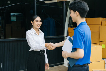 Obraz premium Express Delivery Service. Asian Courier Delivering Package to man Delivery service near van outside the warehouse, delivery home