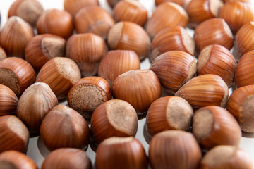 natural hazelnuts on white surface - close macro photo