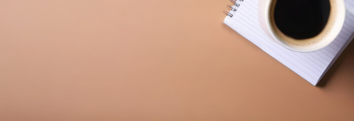 Banner Cup of coffee and stack of paper notebooks on pastel brown background. Business, coffee break concept