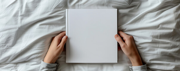 Hand holding a white Blank book mockup with cover paper template. 