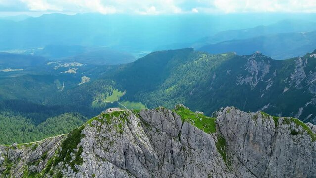 An awe-inspiring aerial view of the Slovenian Alps, featuring the majestic peaks of Vi&scaron;evnik, Jezerca, and Veliki Dra&scaron;ki vrh. These stunning mountains offer breathtaking hiking trails