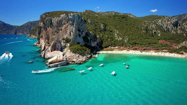 Best and most beautiful beaches of Sardegna island (Italy) - Cala Luna in gulf of Orosei . Aerial panoramic drone view of white sandy beach , caves and turquoise sea. high angle 4khd video