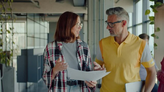 Woman and man walking in office with free dress code