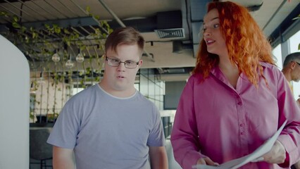 Woman talking to man with developmental disability in office