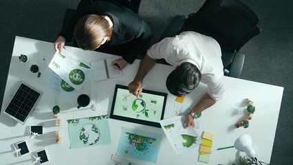 Top down view of business man presenting sustainable idea to manager by using tablet display ESG...