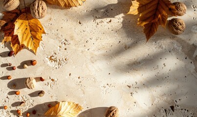Top view of a beige stone countertop, autumn leaves and nuts
