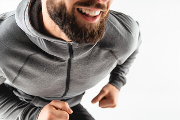 Obraz premium Smiling Man Running in Gray Hoodie