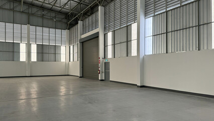 interior factory showing steel roller shutter door, steel fire exit door, metal sheet siding, and louvers.