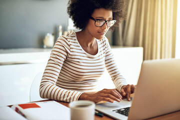 laptop, typing and African woman in living room with remote work for report, review or freelancer. Online, journalist and person for update article, proofreading or working on feature story in home