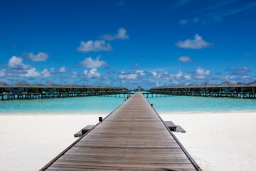 A wooden bridge to the water villas in the Maldives. Photo wallpaper for desktop