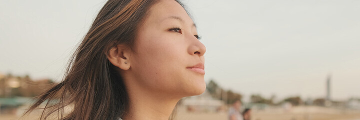 Young beautiful woman walking on the beach, panorama