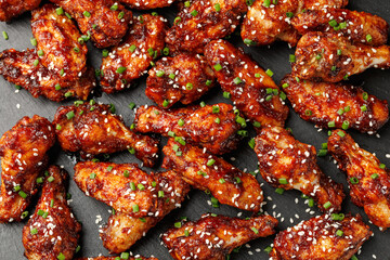 Spicy korean chicken wings with sesame seeds and chives